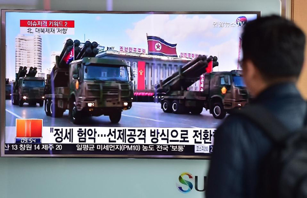 A man in Seoul watches a news report on North Korean missiles on parade in Pyongyang on March 4, 2016 PHOTO: AFP