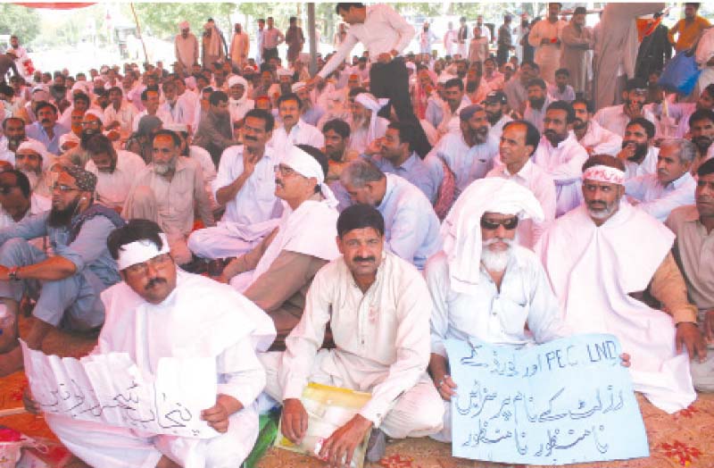 Teachers sit outside the Punjab Assembly on Sunday. PHOTO: EXPRESS
