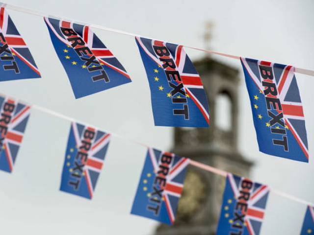 This file photo taken on June 13, 2016 shows Pro-Brexit depicting a Union flag merged with the EU flag, fly from a fishing boat moored in Ramsgate, south-est England. PHOTO: AFP