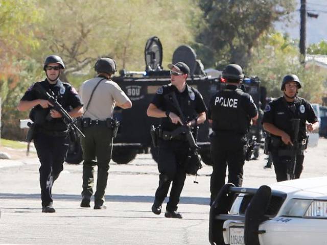 Armed police officers are shown during a standoff where three officers were shot by a suspect in Palm Springs, California, US October 8, 2016. PHOTO: REUTERS