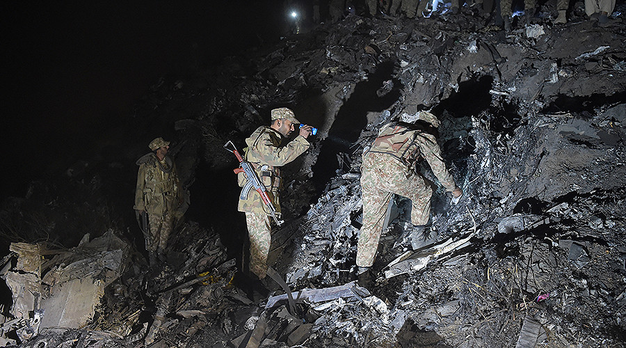 Soldiers search for victims from the wreckage of the crashed PIA passenger plane Flight PK661 at the site near Abbottabad on December 7, 2016. PHOTO: AFP
