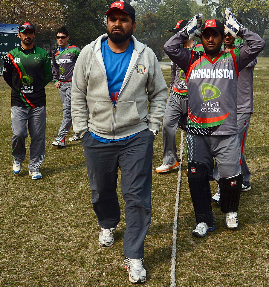 Kabir Khan (C) while coaching Afghanistan players in Lahore on January 31, 2013. PHOTO: AFP
