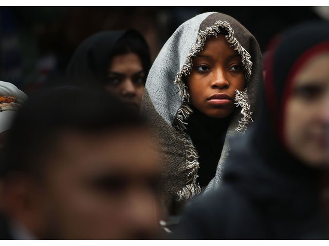 A woman listens to a speaker as area Muslims and local immigration activists participate in a prayer and rally against President Donald Trump's immigration policies on January 27, 2017 in New York City. PHOTO: AFP