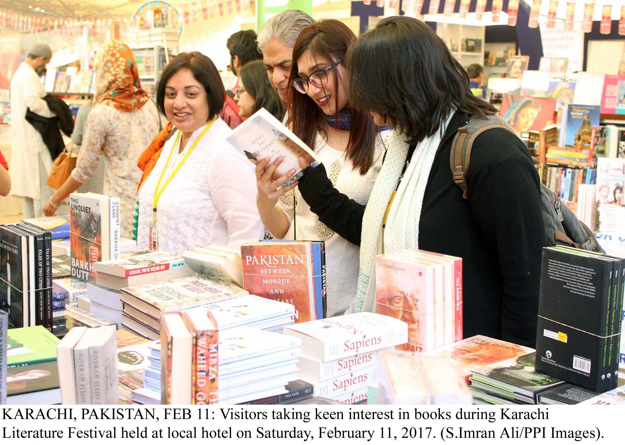 Visitors taking keen interest in books during Karachi Literature Festival. PHOTO: PPI