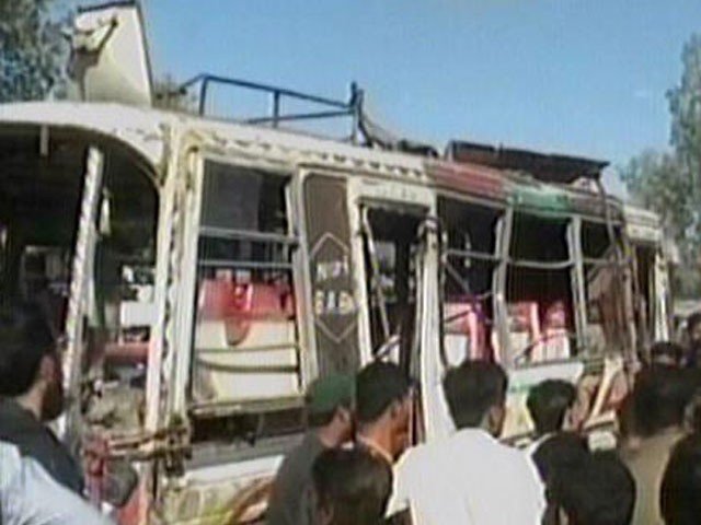 People gather around a bus which overturned on Karachi's University Road on Thursday, February 9, 2017. SCREEN GRAB