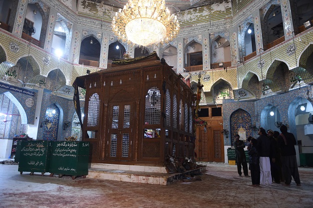 Pakistani devotees stand on the blood-stained floor a day after a bomb attack hit the 13th century Muslim Sufi shrine of Lal Shahbaz Qalandar in the town of Sehwan in Sindh province, some 200 kilometres northeast of the provincial capital Karachi, on February 17, 2017. PHOTO: AFP