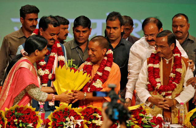 Yogi Adityanath (C) is greeted after he was elected as Chief Minister of India's most populous state of Uttar Pradesh, during the party lawmakers' meeting in Lucknow, India March 18, 2017. PHOTO: REUTERS