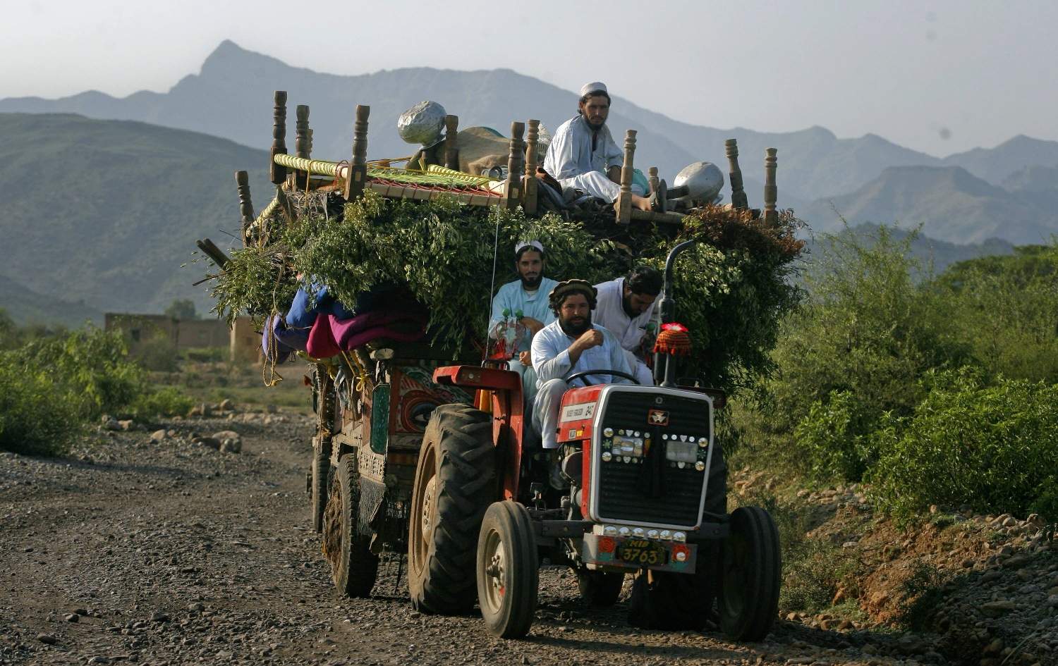 An internally displaced family flee military operations on tractors in Tora Warai, a town in Kurram Agency located in Pakistan's Federally Administered Tribal Areas (FATA) during a military trip organised for media along the Afghanistan border, July 9, 2011. PHOTO: REUTERS