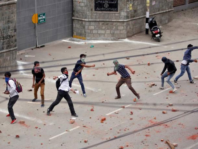 Demonstrators throw stones towards the Indian police during a protest in Srinagar, May 9, 2017. PHOTO: REUTERS