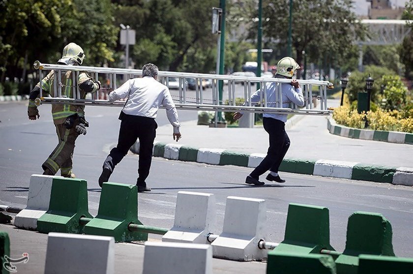 Members of Iranian civil defence run during an attack on the Iranian parliament in central Tehran, Iran, June 7, 2017. PHOTO: REUTERS