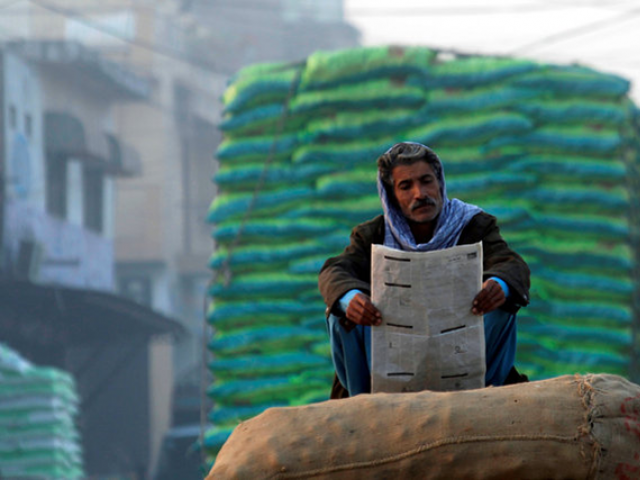 A man reads newspaper in the morning. PHOTO: REUTERS