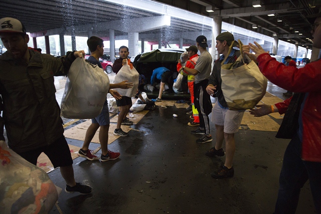 Volunteers unload donated items at the George Brown Convention Center which has been turned into a shelter run by the American Red Cross to house victims of the high water from Hurricane Harvey on August 28, 2017 in Houston, Texas. PHOTO: AFP