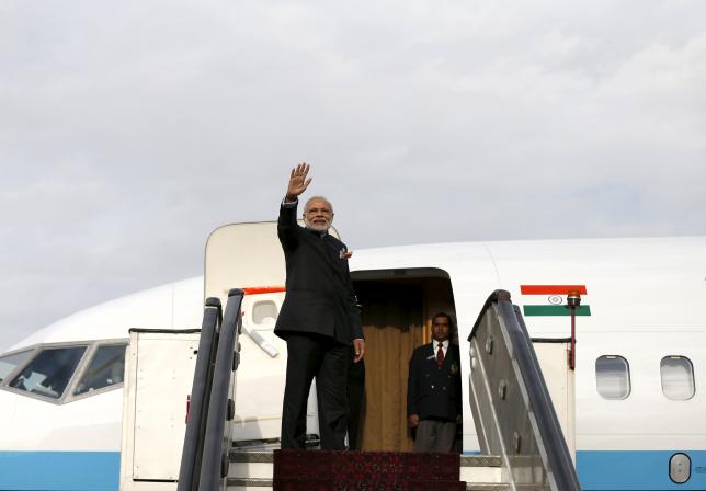 India's Prime Minister Narendra Modi waves as he boards a plane. PHOTO: AFP