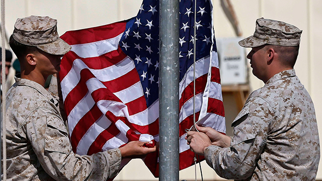American soldiers raise the US flag. PHOTO: REUTERS