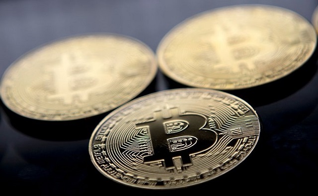 This file photo taken on November 20, 2017 shows gold plated souvenir Bitcoin coins arranged for a photograph in London.
PHOTO: AFP