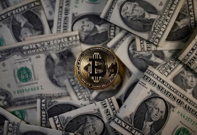 A bitcoin (virtual currency) coin placed on Dollar banknotes is seen in this illustration picture, November 6, 2017.
PHOTO: REUTERS