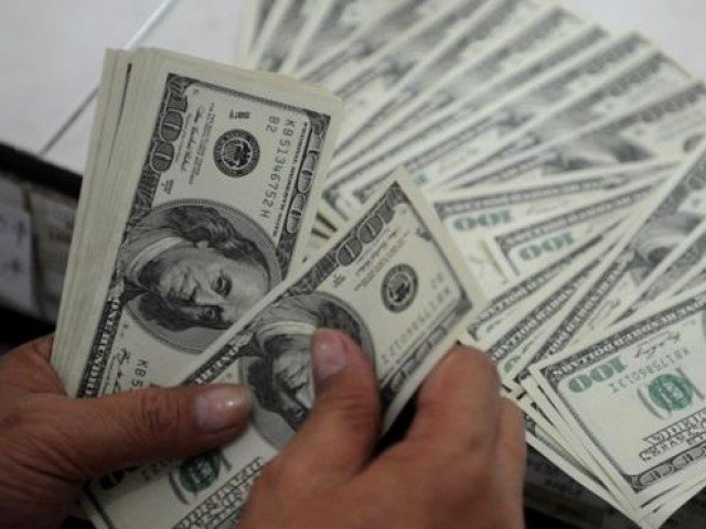 People are converting their savings into the greenback to ward off impact of further rupee depreciation
PHOTO: AFP