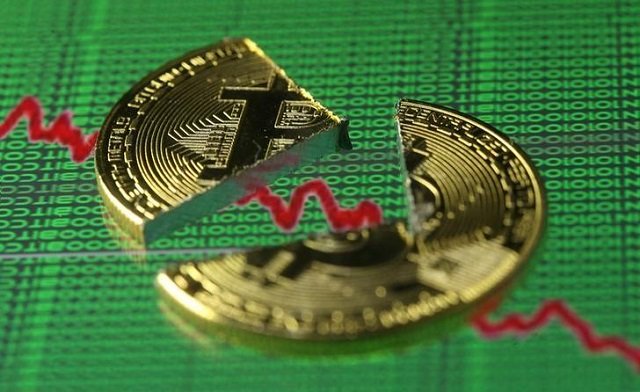 Broken representation of the Bitcoin virtual currency, placed on a monitor that displays stock graph and binary codes, are seen in this illustration picture, December 21, 2017.
PHOTO: REUTERS
