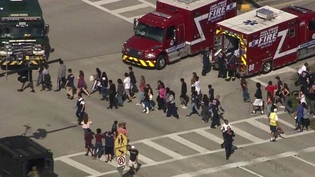 Students are evacuated from Marjory Stoneman Douglas High School during a shooting incident in Parkland, Florida. PHOTO: REUTERS