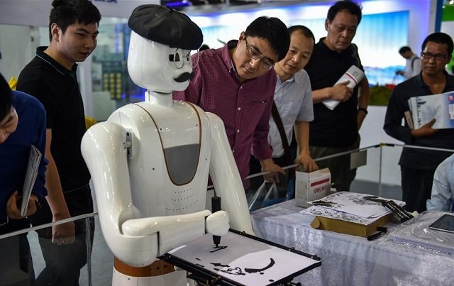 People watch a robot painting demonstration during the 19th China Hi-tech Fair in Shenzhen, south China's Guangdong Province, November 16, 2017.
PHOTO: XINHUANET