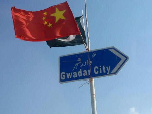 The Chinese and Pakistani flags fly on a sign along a road towards Gwadar, Pakistan January 26, 2016. PHOTO: REUTERS