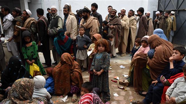 Afghan refugees gather for renewal of their family cards at the Chamkany registration center on the outskirts of Peshawar. PHOTO: AFP
