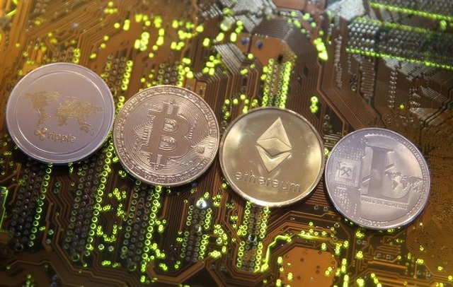 Representations of the Ripple, Bitcoin, Etherum and Litecoin virtual currencies are seen on a PC motherboard in this illustration picture, February 13, 2018.
PHOTO: REUTERS