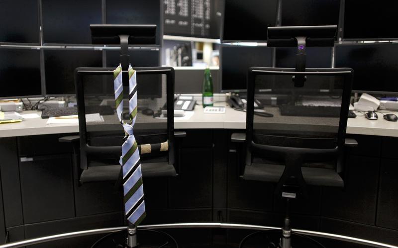 A tie hangs from an empty chair on a desk. PHOTO: REUTERS