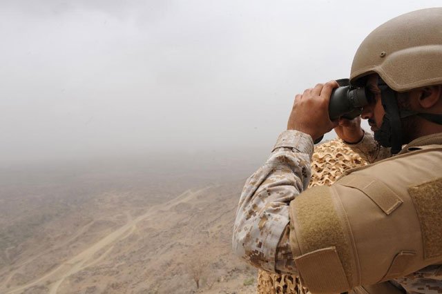 A Saudi soldier looks through binoculars from a position on the Saudi-Yemeni border. PHOTO: AFP
