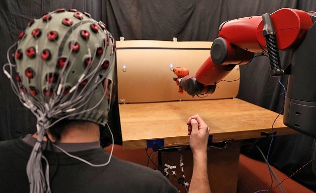 The robot responds to hand gestures from the person. PHOTO: MIT
