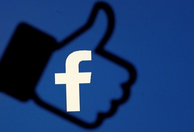 FILE PHOTO: A 3D-printed Facebook like button is seen in front of the Facebook logo. PHOTO: REUTERS