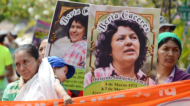 Banners at a protest for slain environmentalist. PHOTO: AFP.