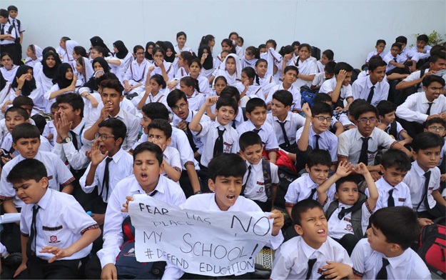 Students of a private school protest against sealing of their school. PHOTO: ONLINE