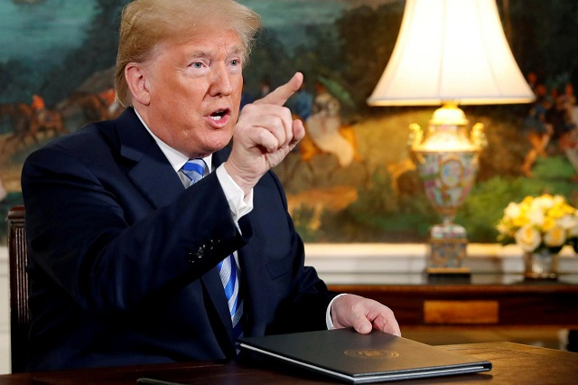 US President Donald Trump speaks to reporters after signing a proclamation declaring his intention to withdraw from the JCPOA Iran nuclear agreement in the Diplomatic Room at the White House in Washington, U.S. May 8, 2018. PHOTO: REUTERS