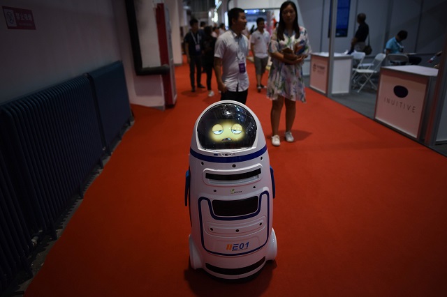 (FILES) This file photo taken on August 15, 2018 shows a robot moving at the 2018 World Robot Conference in Beijing. - The popular stars of this year's World Robot Conference, which ends on August 19, 2018, were undoubtedly the small, amateur-made "battle bots" which smashed, hammered and sawed their way through their opponents to a cacophony of cheers and shouts from a rapt audience. PHOTO: AFP