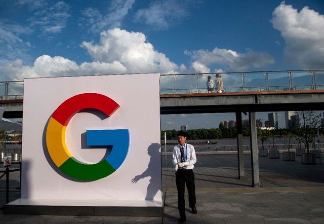 A man passes a Google sign in Shanghai on September 26, 2018.
PHOTO: APF