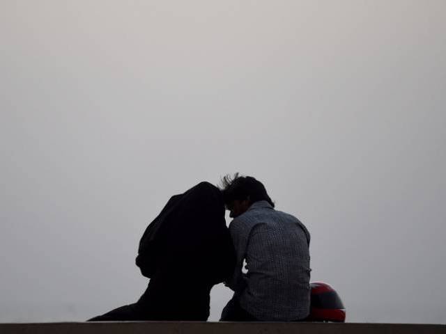 A young couple at Karachi's seaview beach. PHOTO: FILE
