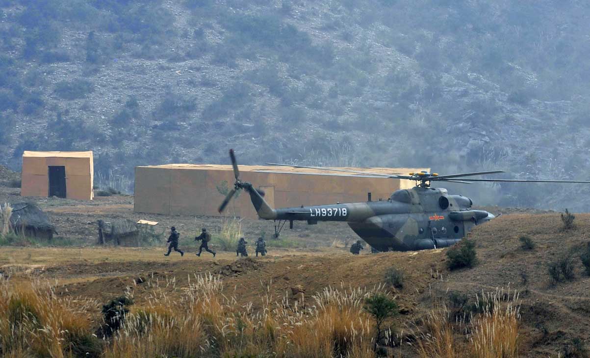 Chinese People's Liberation Army (PLA) soldiers take part in the Pakistan-China anti-terrorist drill as they wrap up their two-week military exercise in Jhelum on November 24, 2011. PHOTO: AFP