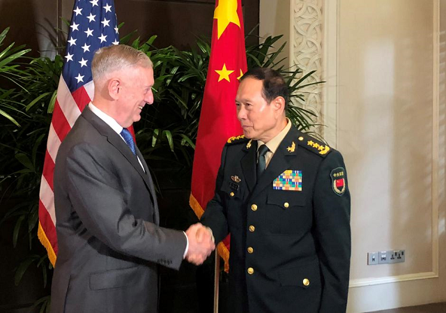 US Defense Secretary Jim Mattis and China's Defense Minister Wei Fenghe greet each other ahead of talks in Singapore, October 18, 2018. PHOTO: REUTERS
