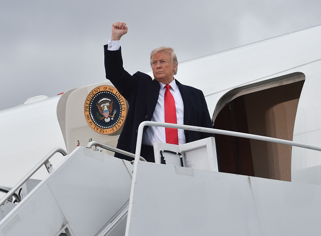 US President Donald Trump gestures before boarding Airforce One after a campaign rally at the Huntington Tri-State Airport, on November 2, 2018, in Huntington, West Virginia. PHOTO: AFP