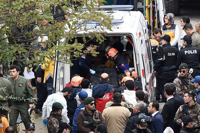 This handout picture released by Demiroren News Agency shows rescue workers and emergency services members carrying a coffin of a soldier who died after a helicopter crash in Istanbul, on November 26, 2018. PHOTO: AFP