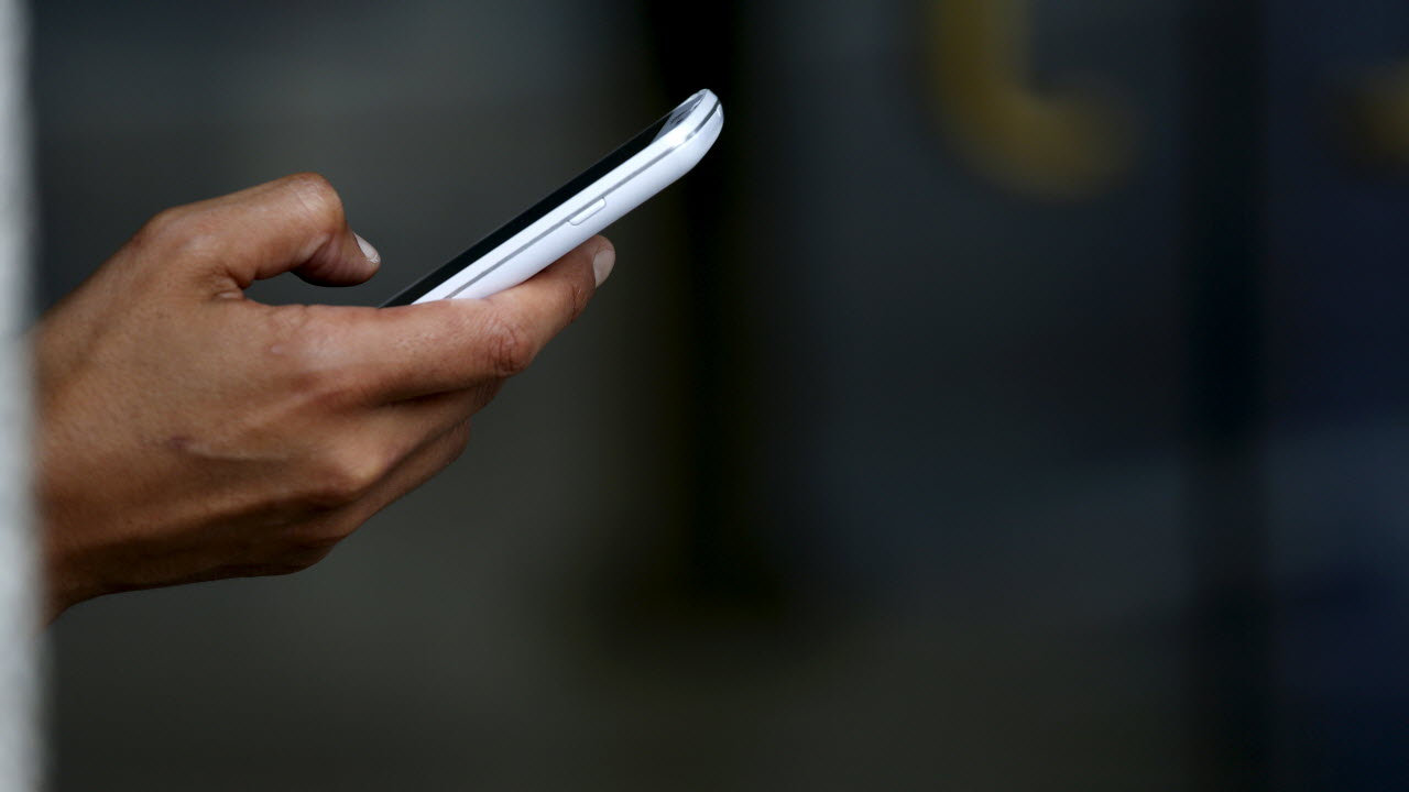 Representational image of a man using mobile phone. PHOTO: REUTERS