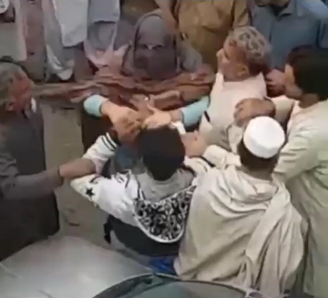 In the video footage, a woman can be seen furiously slapping and roughing up the two men. PHOTO: SCREEN GRAB