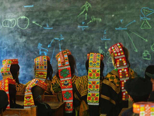 In this photograph taken on October 31, 2015, Kalash students attend a class at a school in the Brun village of Bumboret valley. PHOTO: AFP