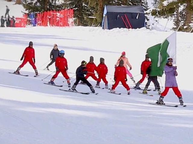 A group of young skiers displaying the Pakistani flag during the opening round of Sadia Khan Ski Cup on Friday. PHOTO: PAF