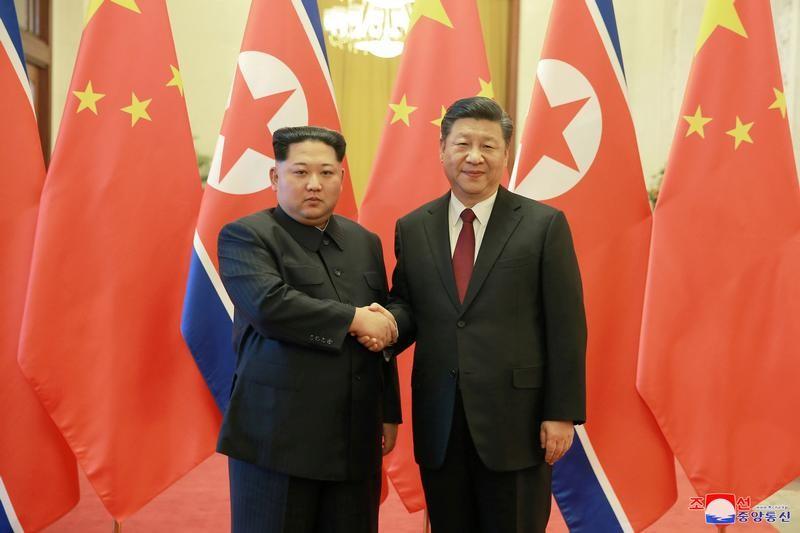 North Korean leader Kim Jong Un shakes hands with Chinese President Xi Jinping in Beijing. PHOTO: REUTERS