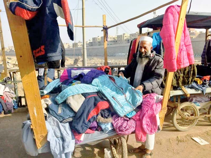 A displaced vendor of Lighthouse takes a make-shift stall to roads and intersections. PHOTO: EXPRESS