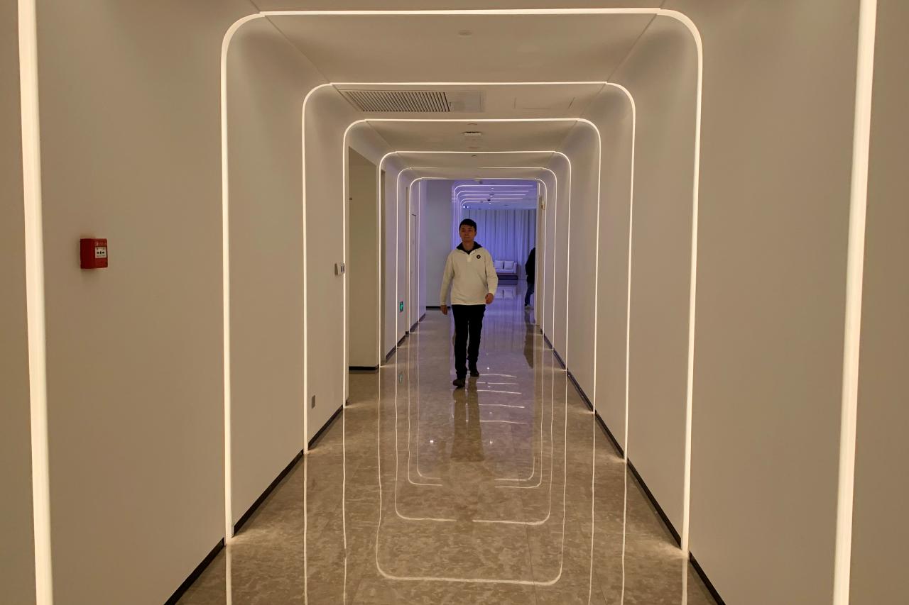 A staff member walks in the hallway during a demonstration to the media at Alibaba Group's futuristic FlyZoo hotel in Hangzhou, Zhejiang province, China. PHOTO: REUTERS