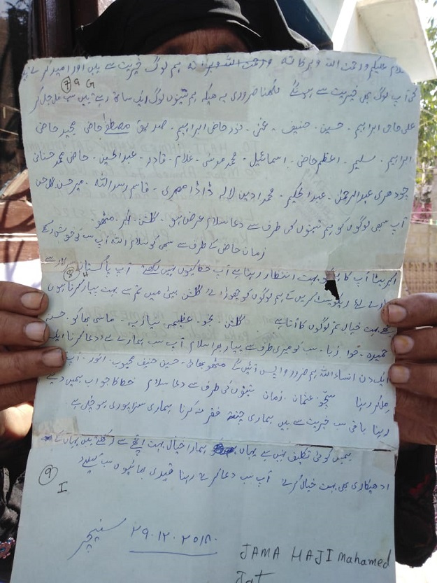 Woman holding letter sent by her brother (fisherman imprisoned in India). PHOTO: Express