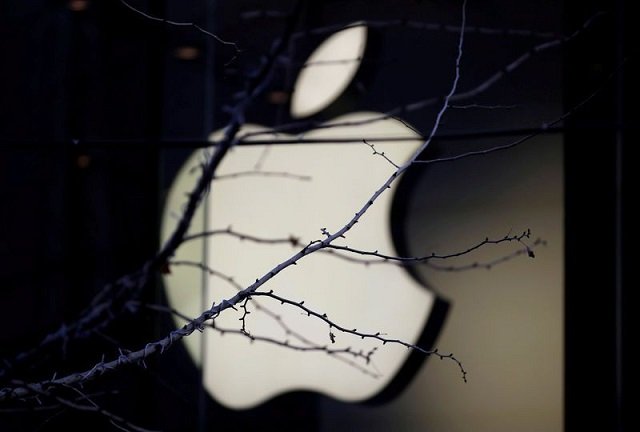 An Apple company logo is seen behind tree branches outside an Apple store in Beijing, China December 14, 2018.
PHOTO: REUTERS